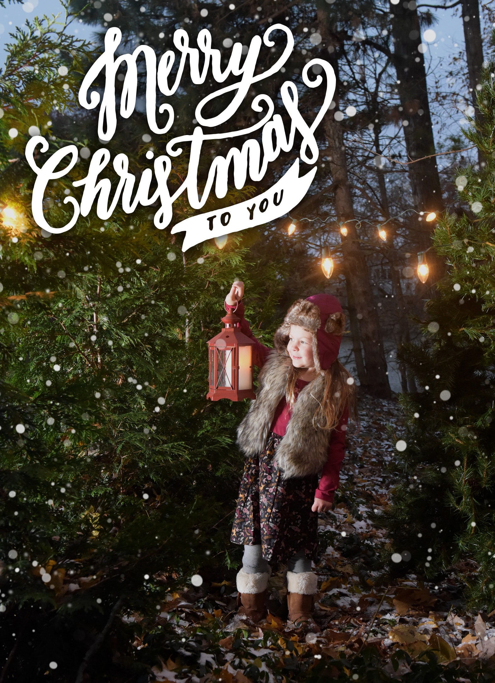 Child holding lantern in snowy forest