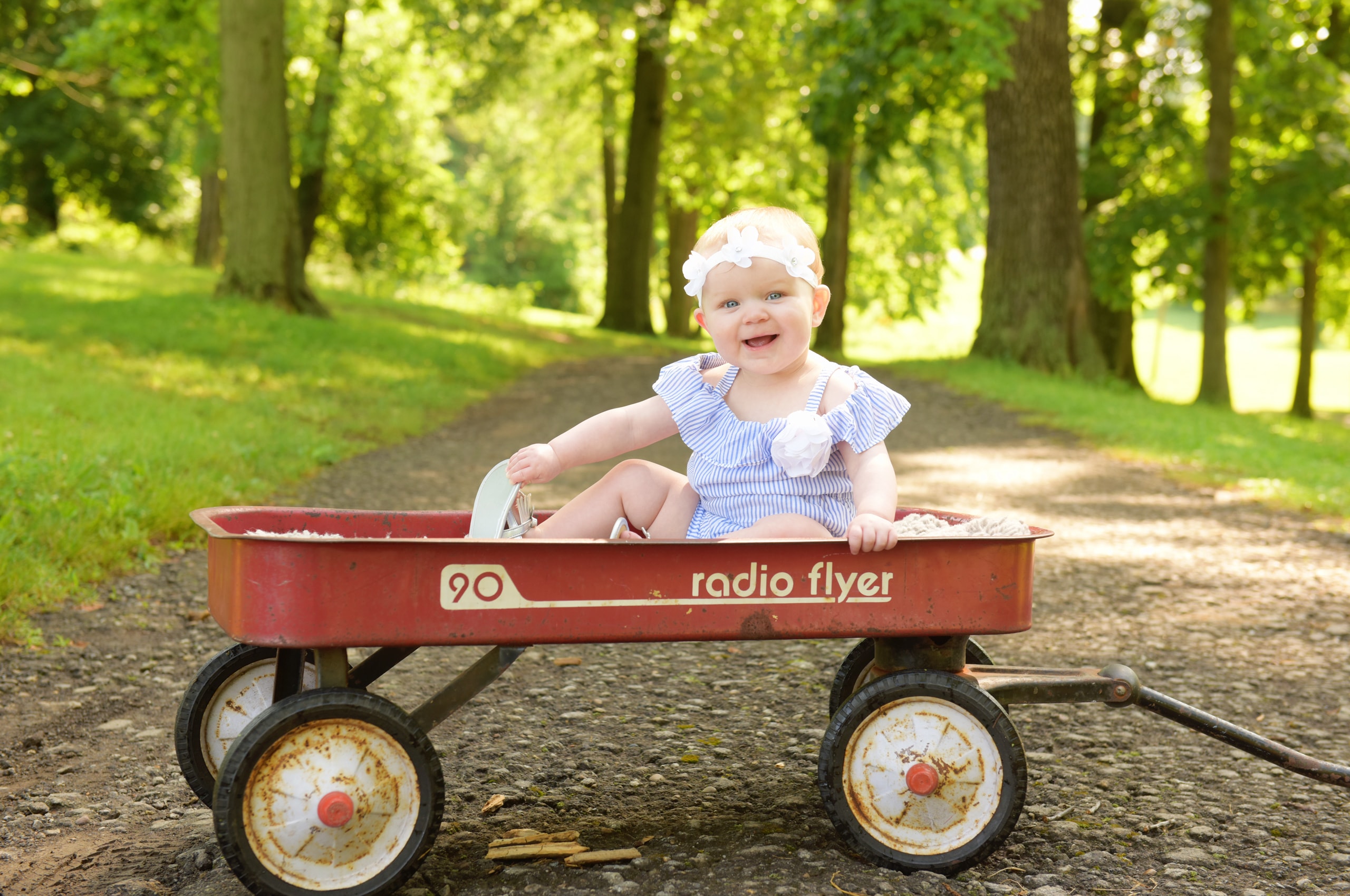 Happy baby in vintage Radio Flyer wagon