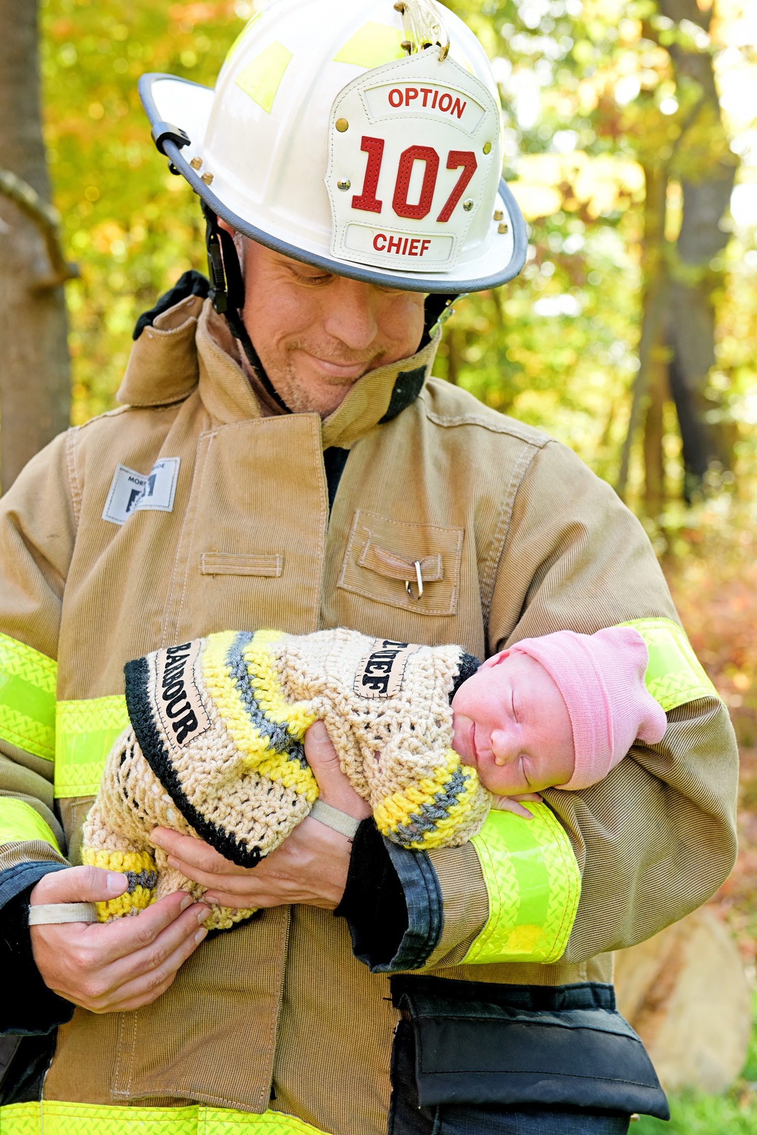 Firefighter holding rescued kitten outdoors