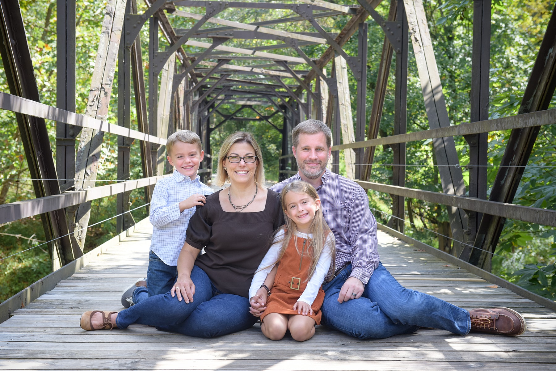 Family of four on wooden bridge